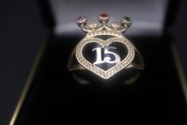 14 K Gold Ring (Quinceanera) ring with a heart in the middle center by "15" and topped by three colored stones.  Weight: 3.2 G  Size: 8