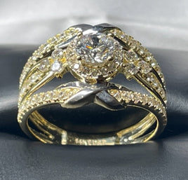 14 K Gold Ring CZ ring with three compartments; the middle has a big CZ stone, and the other two have a tiny ribbon on both sides.   Weight: 3.6 G  Size: 7