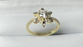 14 K Gold Ring CZs flower-shaped ring with a giant CZ stone in the middle surrounded by six tiny CZ stones.  Weight: 2.9 G  Size: 7